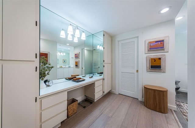 bathroom with a shower, vanity, and hardwood / wood-style flooring