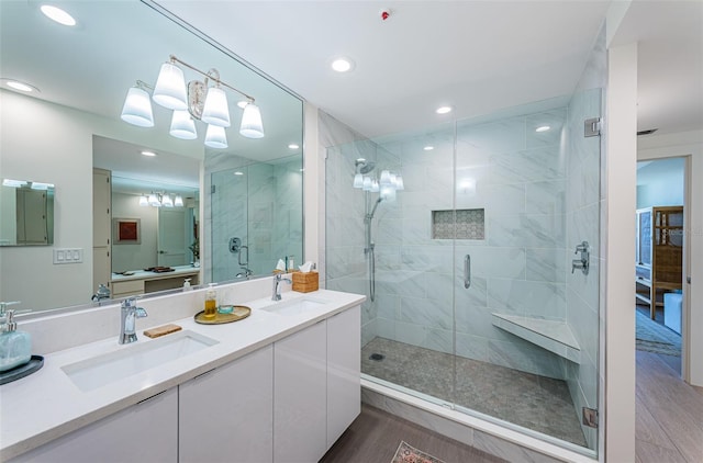 bathroom with vanity and a shower with door