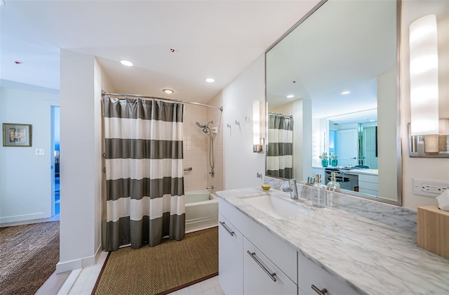 bathroom featuring shower / bath combo with shower curtain, tile floors, and vanity