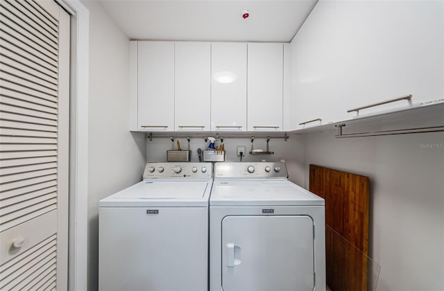 washroom with cabinets and separate washer and dryer