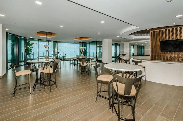 dining space featuring floor to ceiling windows and light wood-type flooring