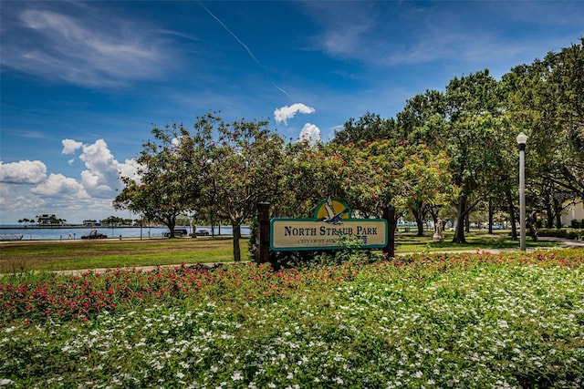 community sign with a water view