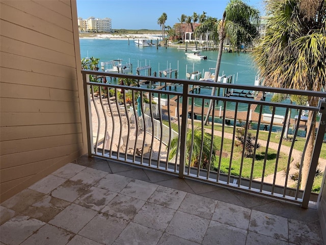 balcony featuring a dock and a water view