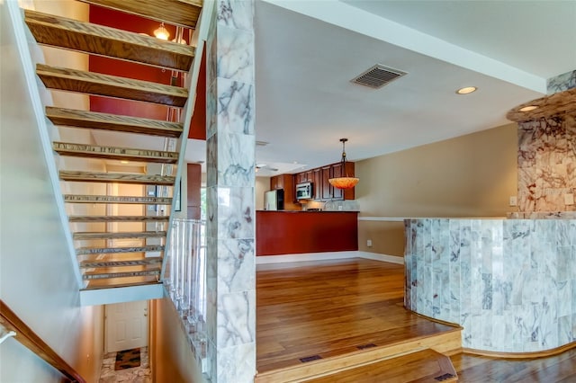 staircase featuring wood-type flooring