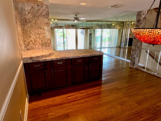 kitchen featuring ceiling fan and dark hardwood / wood-style flooring