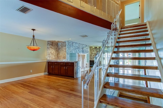 stairway featuring light hardwood / wood-style flooring