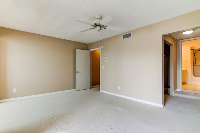 empty room featuring light carpet and ceiling fan