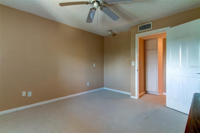 carpeted empty room with a textured ceiling and ceiling fan