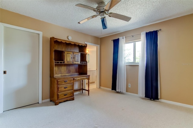 interior space with a textured ceiling and ceiling fan