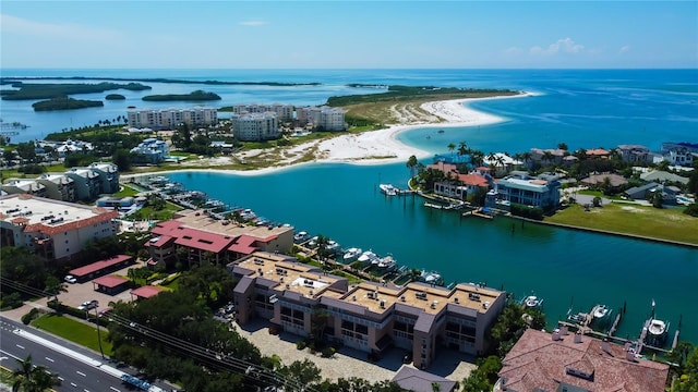 drone / aerial view with a water view and a beach view