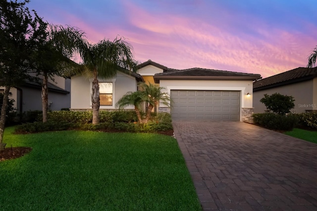 view of front of home featuring a lawn and a garage