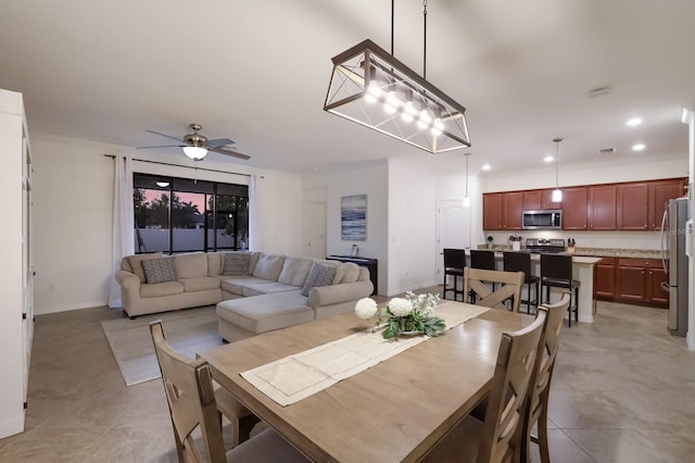 dining room with ceiling fan with notable chandelier and light tile flooring