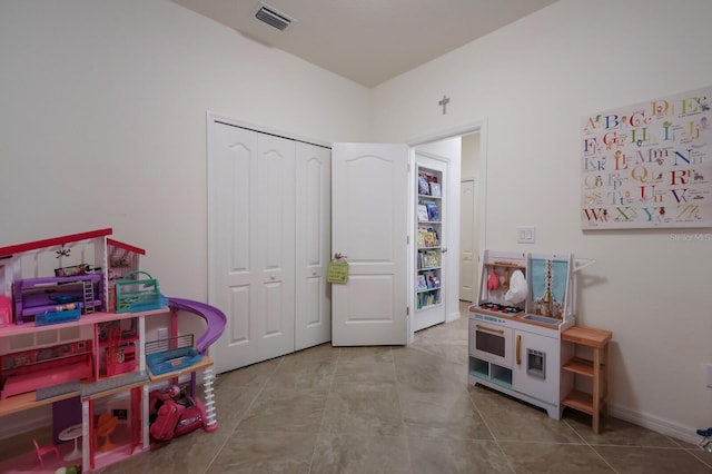 recreation room with light tile floors