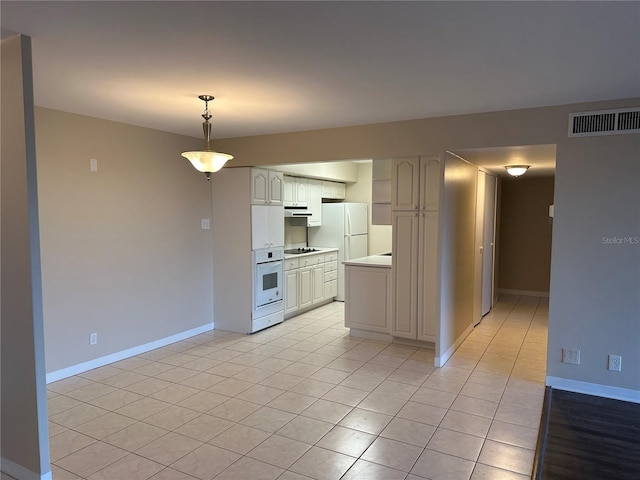 kitchen with visible vents, white appliances, light countertops, baseboards, and hanging light fixtures