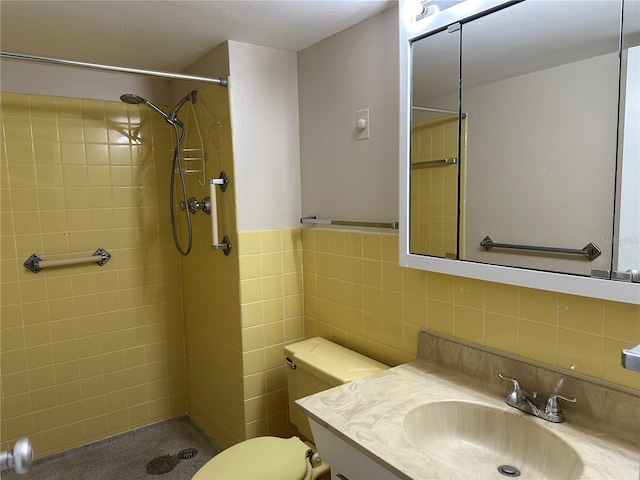 full bathroom with toilet, tile walls, a stall shower, and vanity