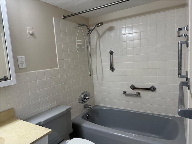 full bathroom with vanity, tile walls, toilet, and shower / bathtub combination