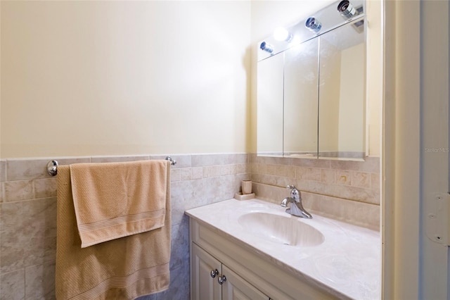 bathroom with tile walls, large vanity, and tasteful backsplash