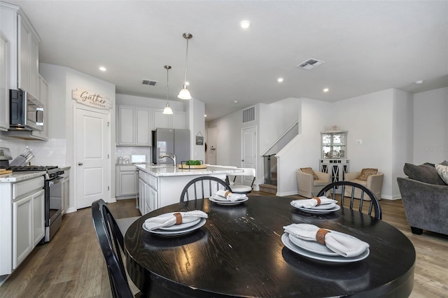 dining room featuring sink and hardwood / wood-style flooring