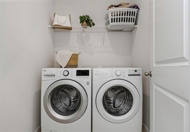 washroom with washing machine and dryer