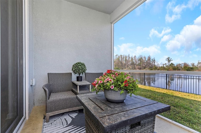 balcony featuring a water view