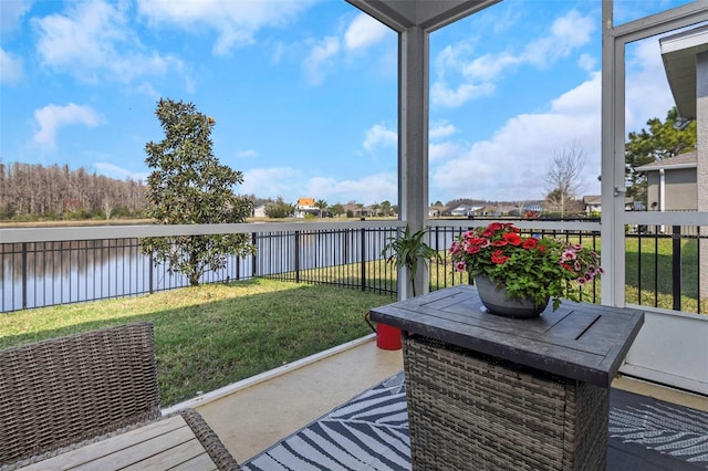 sunroom / solarium featuring a water view