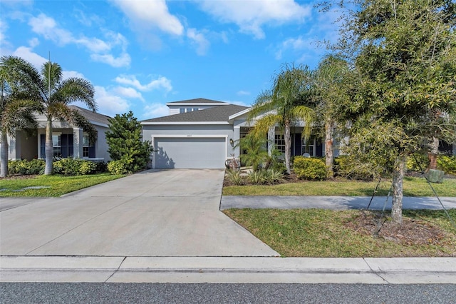 view of front of home with a garage and a front lawn