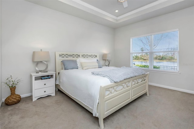 bedroom featuring recessed lighting, a tray ceiling, baseboards, and light colored carpet