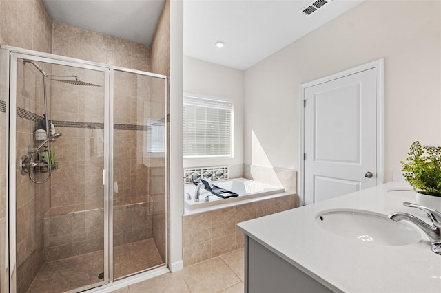 bathroom with visible vents, a sink, a shower stall, a garden tub, and tile patterned floors