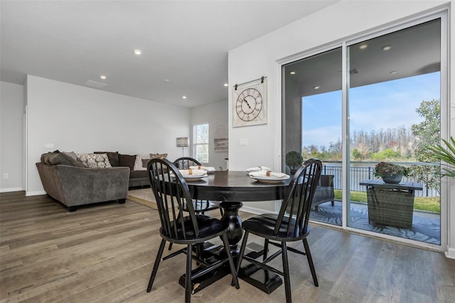 dining room featuring recessed lighting, baseboards, and wood finished floors