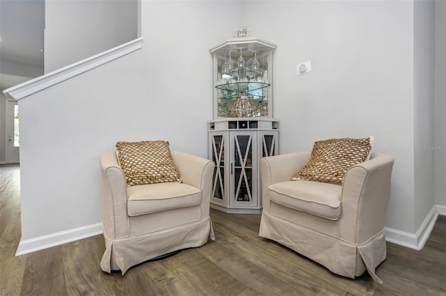 sitting room with baseboards and wood finished floors