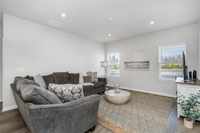 living room with visible vents, recessed lighting, baseboards, and wood finished floors