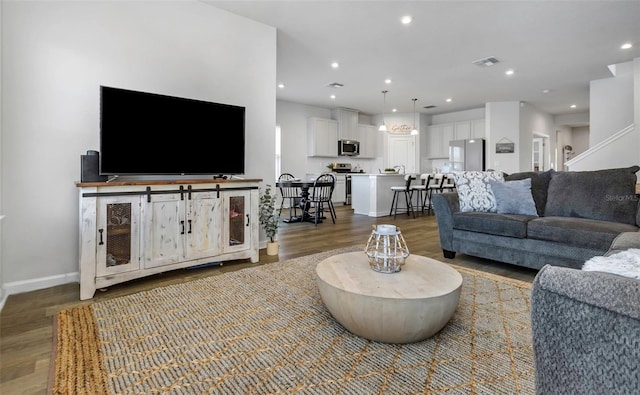 living room featuring visible vents, recessed lighting, and wood finished floors