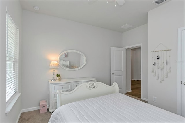 bedroom featuring visible vents, baseboards, a ceiling fan, and carpet flooring