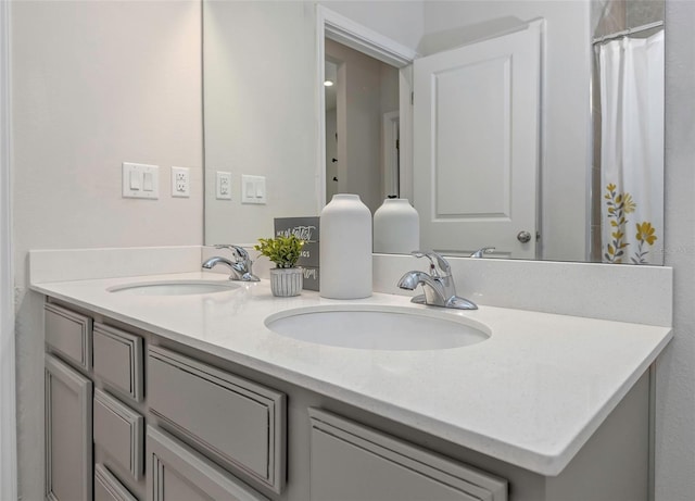 full bathroom featuring double vanity and a sink