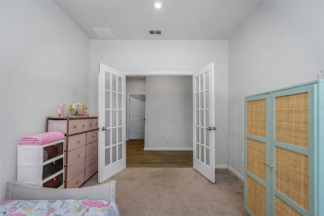 carpeted bedroom with french doors, baseboards, and visible vents