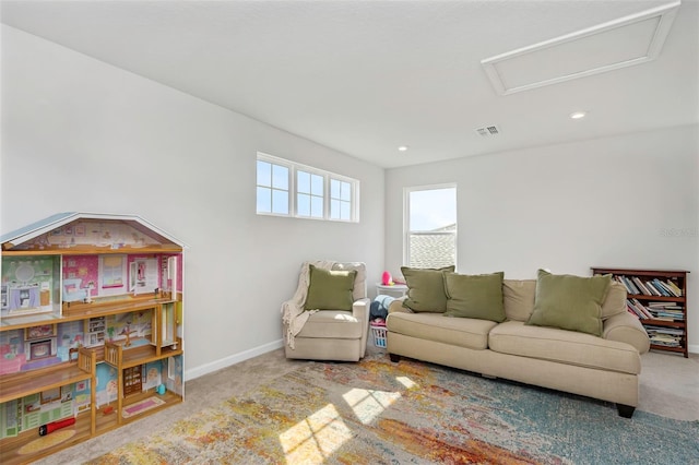 carpeted living room with visible vents, recessed lighting, attic access, and baseboards