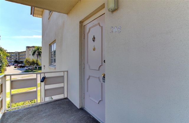 entrance to property with a balcony