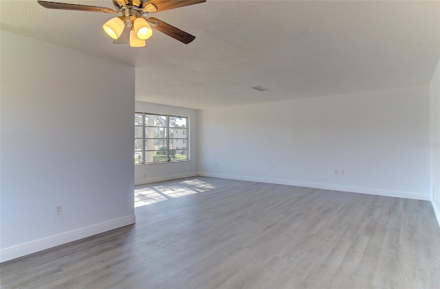 unfurnished room with light hardwood / wood-style floors, ceiling fan, and a textured ceiling