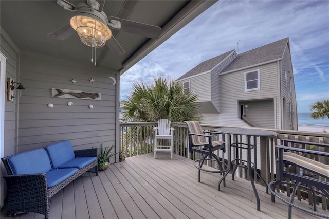 wooden terrace featuring outdoor lounge area, a water view, and ceiling fan