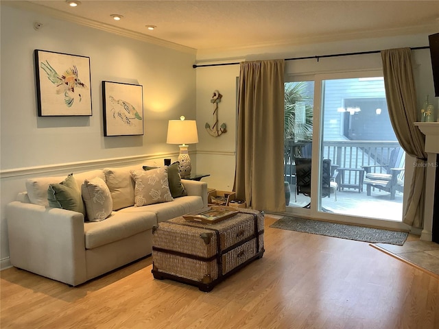 living room featuring light wood-type flooring and crown molding