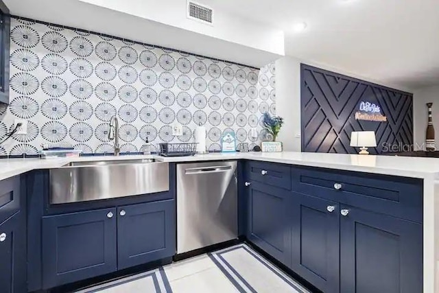 kitchen featuring blue cabinetry, sink, light tile floors, and dishwasher