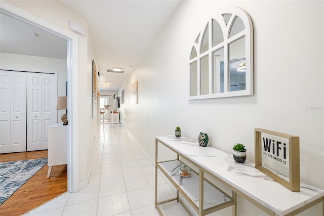 corridor with light tile floors