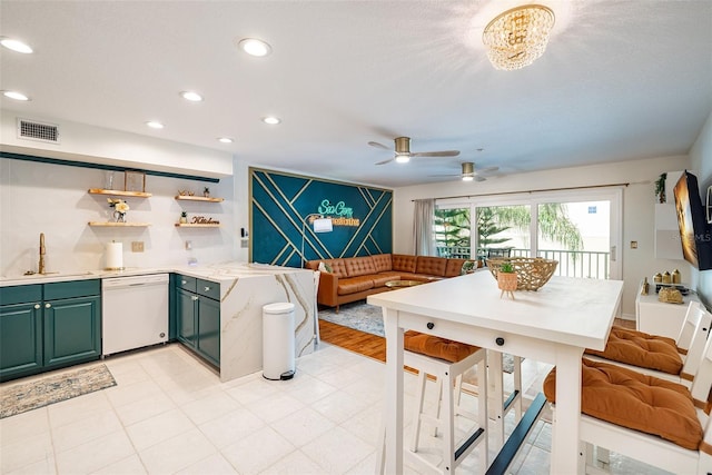 kitchen with ceiling fan, dishwasher, sink, and a textured ceiling