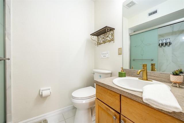 bathroom featuring vanity, tile patterned flooring, a shower with shower door, and toilet