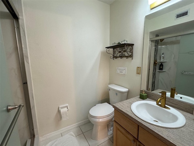 bathroom featuring vanity, tile patterned flooring, a shower with shower door, and toilet