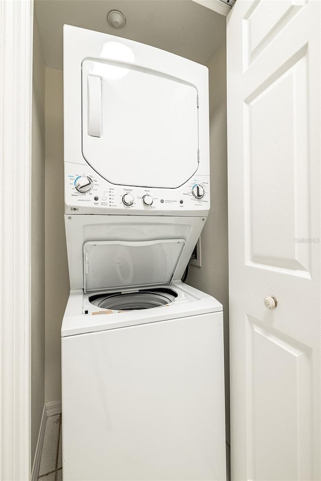 laundry room with stacked washing maching and dryer