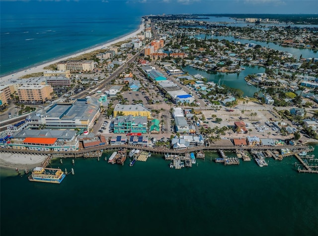 birds eye view of property with a beach view and a water view