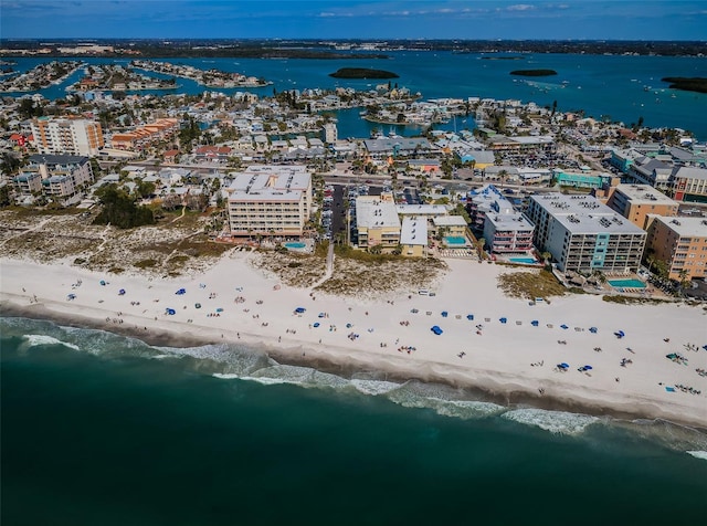 drone / aerial view featuring a water view and a view of the beach