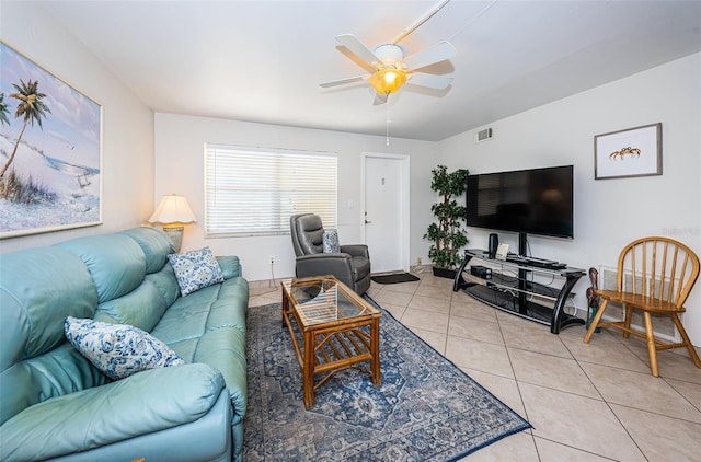 living room with light tile floors and ceiling fan