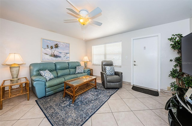 living room featuring light tile flooring and ceiling fan